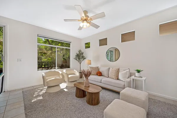 a living room with furniture a chandelier and a fireplace