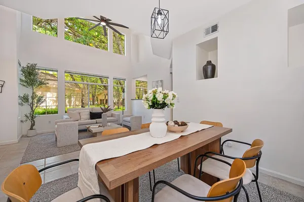 a dining room with furniture and wooden floor