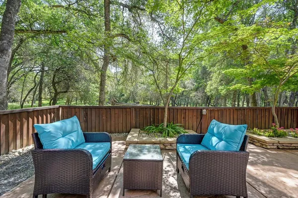 a view of chair and table in the back yard