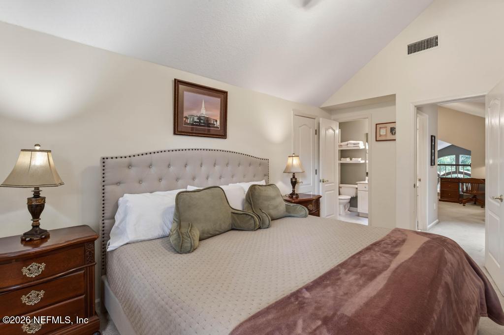 1483 Bridgette Way Fleming Island, FL 32003 - Photo 48 of 63 a bedroom with a bed and a lamp