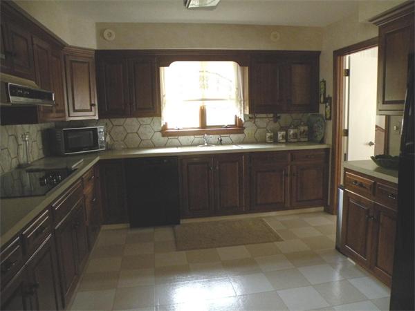 47 Algonquin Road Canton, MA 02021 - Photo 7 of 16 a kitchen with granite countertop a refrigerator and a stove
