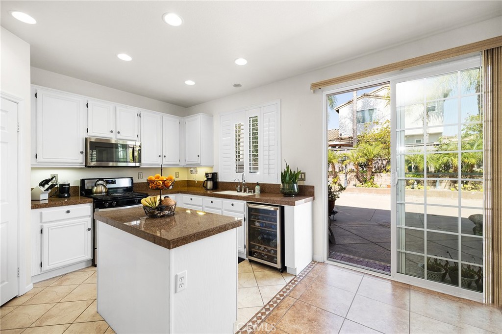 1427 Marble Canyon Way Chula Vista, CA 91915 - Photo 11 of 60 a kitchen with a stove a sink a microwave and refrigerator