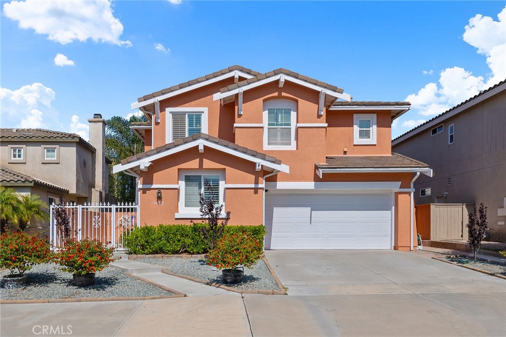 1427 Marble Canyon Way Chula Vista, CA 91915 - Photo 2 of 60 a front view of a house with a yard and garage
