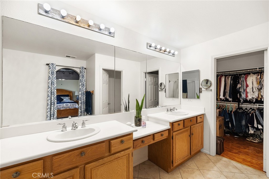 1427 Marble Canyon Way Chula Vista, CA 91915 - Photo 23 of 60 a bathroom with a double vanity sink and a