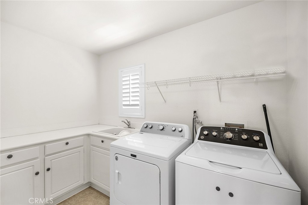 1427 Marble Canyon Way Chula Vista, CA 91915 - Photo 28 of 60 a view of a storage and utility room with washer and dryer