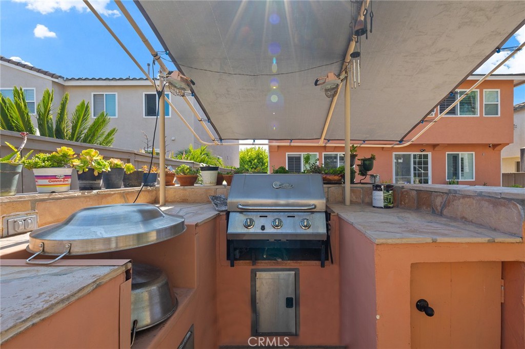 1427 Marble Canyon Way Chula Vista, CA 91915 - Photo 38 of 60 a utility room with stainless steel appliances granite countertop a sink a stove and a refrigerator