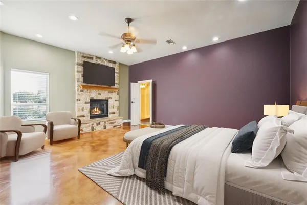 a spacious bedroom with a bed a couch and dresser