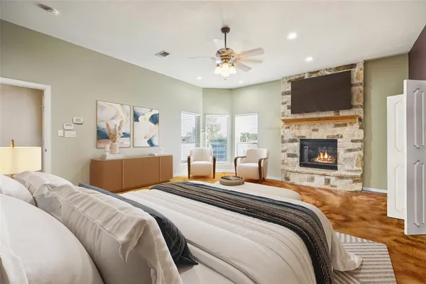 a bedroom with a large bed and a flat screen tv