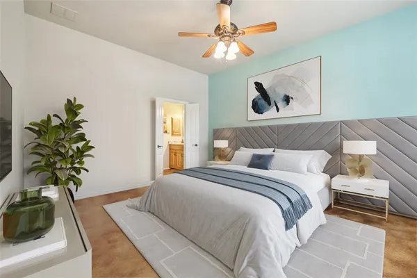 a bedroom with a bed and a potted plant