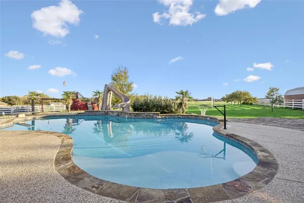 a view of a swimming pool with a table and chairs