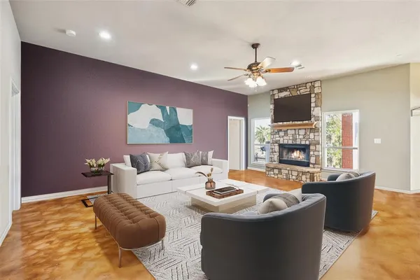 a living room with fireplace furniture and a chandelier