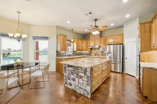 a kitchen with stainless steel appliances granite countertop a stove and refrigerator