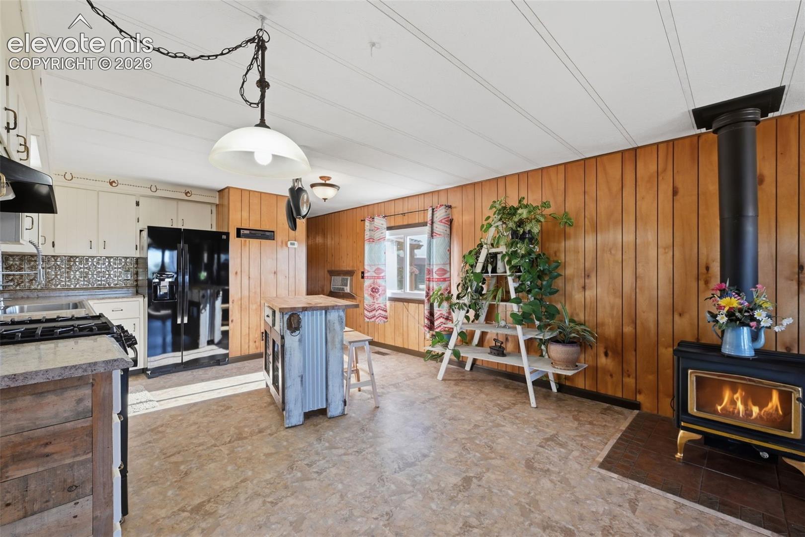 6015 West Condor Road Peyton, CO 80831 - Photo 24 of 50 Wood paneling and white ceiling planks complement wood-finish flooring