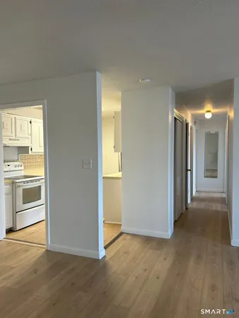 a view of a kitchen with a sink and a refrigerator