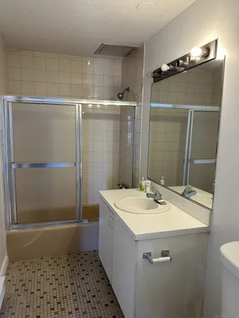 a bathroom with a sink a shower and a mirror