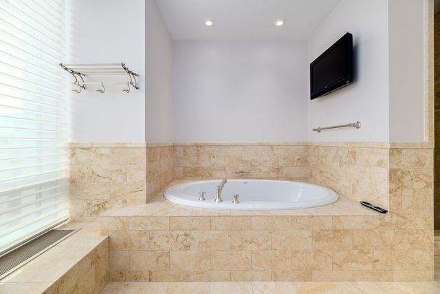 a bathroom with a bathtub and a shower