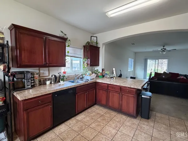 a kitchen with granite countertop a sink and cabinets