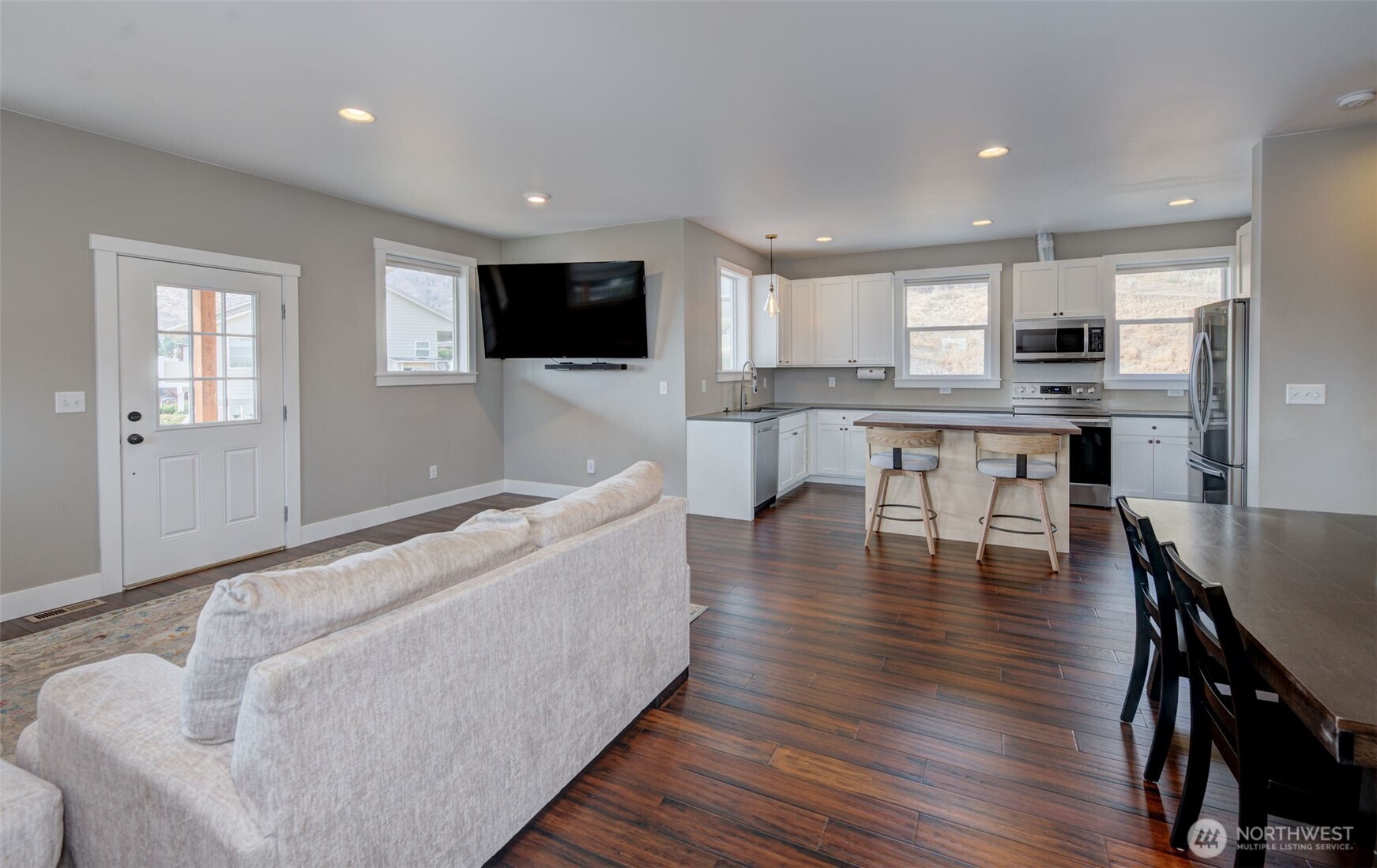 1900 Cumbo Court Wenatchee, WA 98801 - Photo 7 of 33 a living room with furniture a flat screen tv and kitchen view