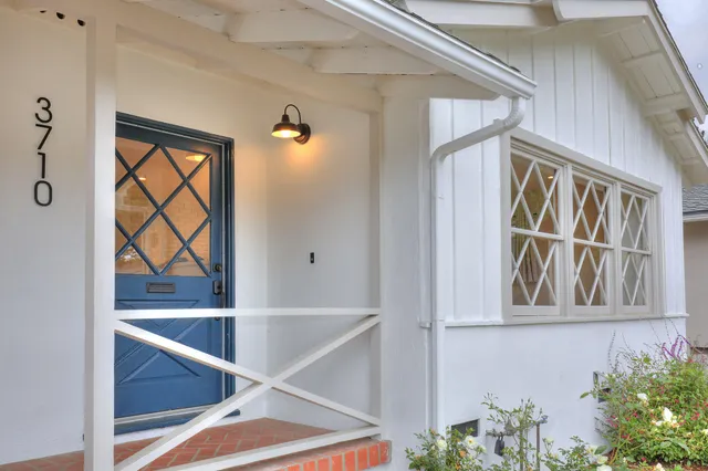 wooden floor in an empty room with a kitchen