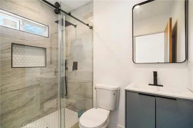 a bathroom with a toilet sink and shower