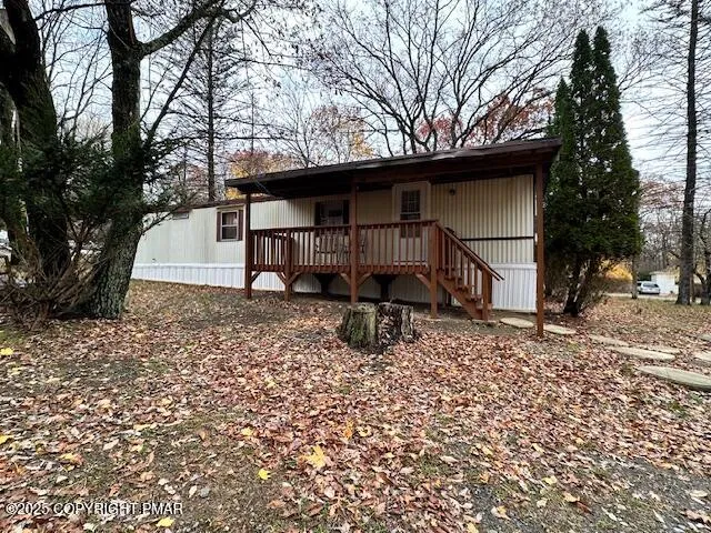 a small barn with a big yard and large trees
