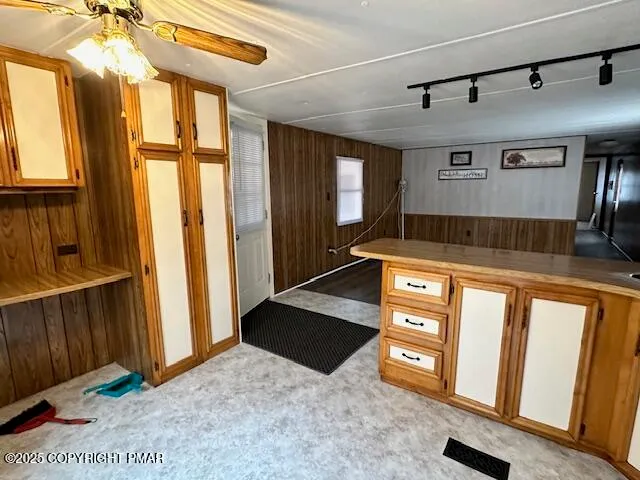 a kitchen with stainless steel appliances granite countertop a refrigerator and a stove