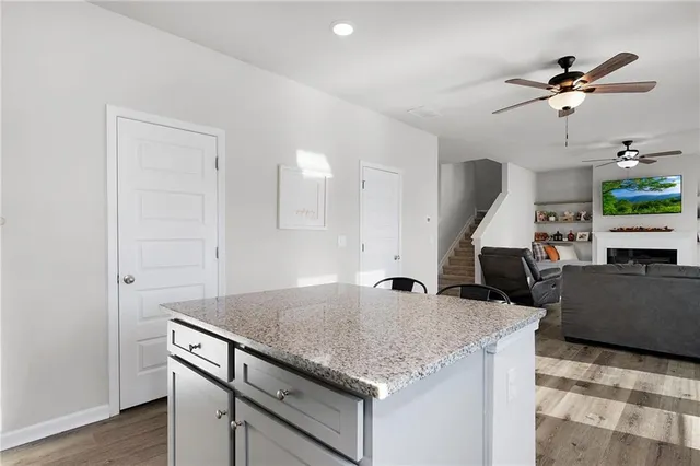 a kitchen with kitchen island a counter top space a sink and appliances