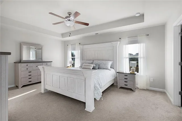 a bed room with a bed and a ceiling fan