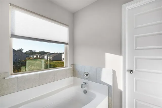 a bathroom with a bathtub and window