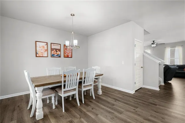 a view of a dining room with furniture wooden floor and a chandelier
