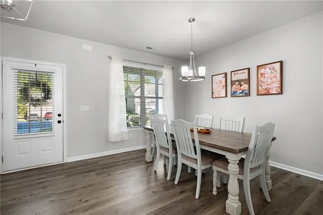 a view of a dining room with furniture wooden floor and chandelier