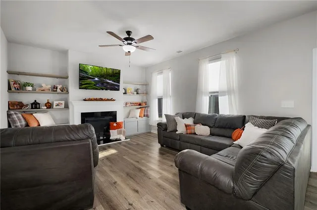 a living room with furniture a fireplace and a flat screen tv