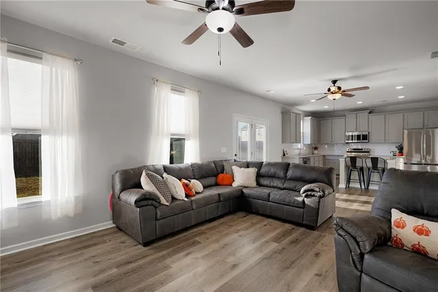 a living room with furniture and a chandelier