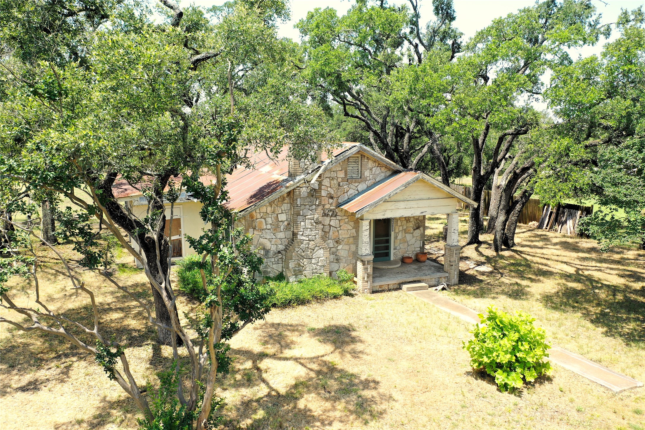 12600 Trail Driver Street Austin, TX 78737 - Photo 2 of 15 a wooden house with trees in front of it