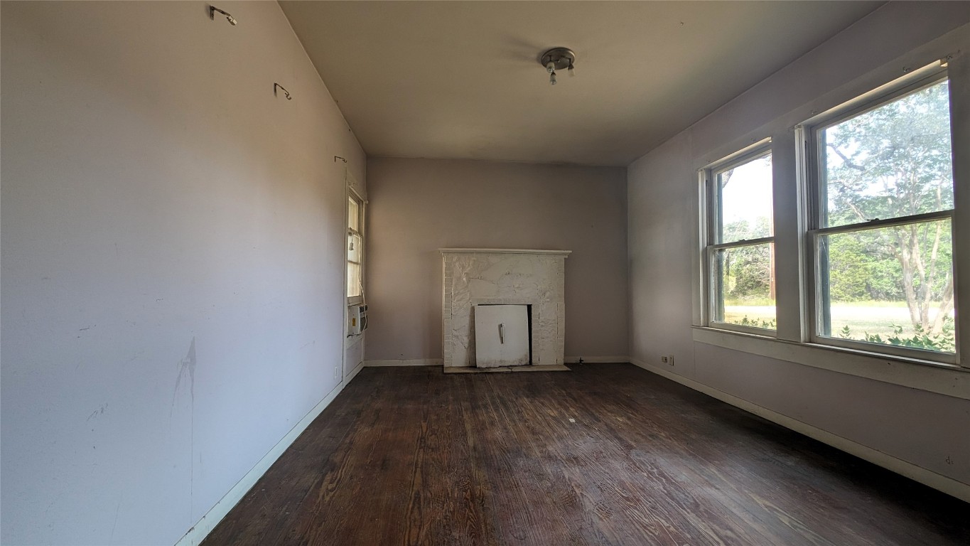 12600 Trail Driver Street Austin, TX 78737 - Photo 8 of 15 an empty room with wooden floor and windows