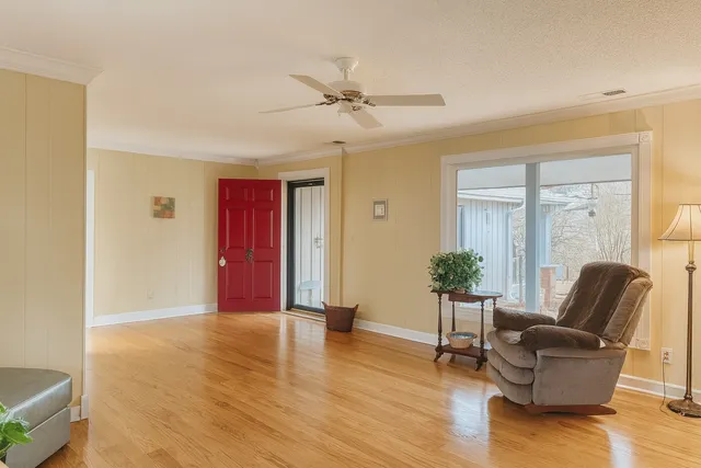 a living room with furniture and wooden floor