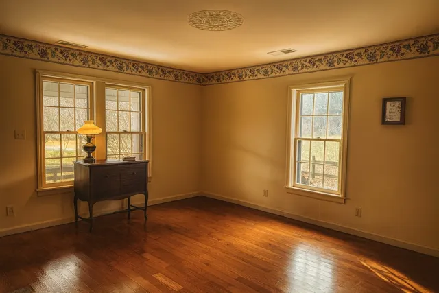 a view of a livingroom with furniture wooden floor and a window