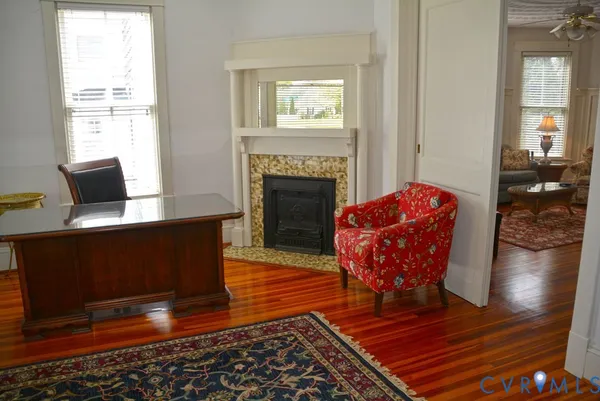 a living room with furniture wooden floor and a fireplace