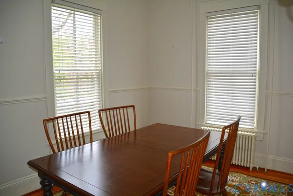 a view of a dining room with furniture and wooden floor