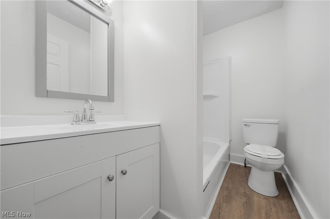 225 Cranz Place Akron, OH 44310 - Photo 18 of 34 Full bathroom featuring vanity, dark wood-style floors, and washtub / shower combination