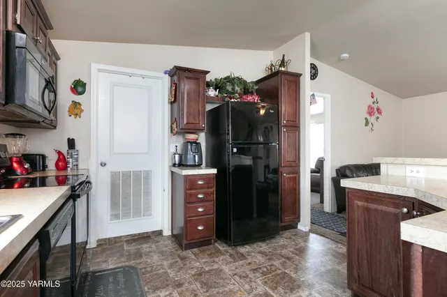 a kitchen with stainless steel appliances a refrigerator sink and cabinets