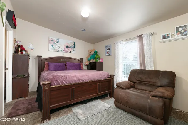 a bedroom with a bed couch and window