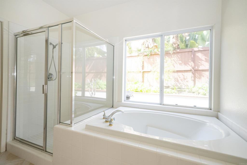 5210 Candlelight Street Oceanside, CA 92056 - Photo 17 of 30 a bathroom with a bathtub and a shower