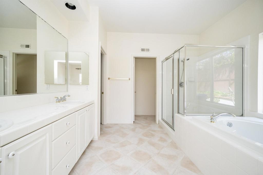 5210 Candlelight Street Oceanside, CA 92056 - Photo 18 of 30 a spacious bathroom with a bathtub shower sink and mirror