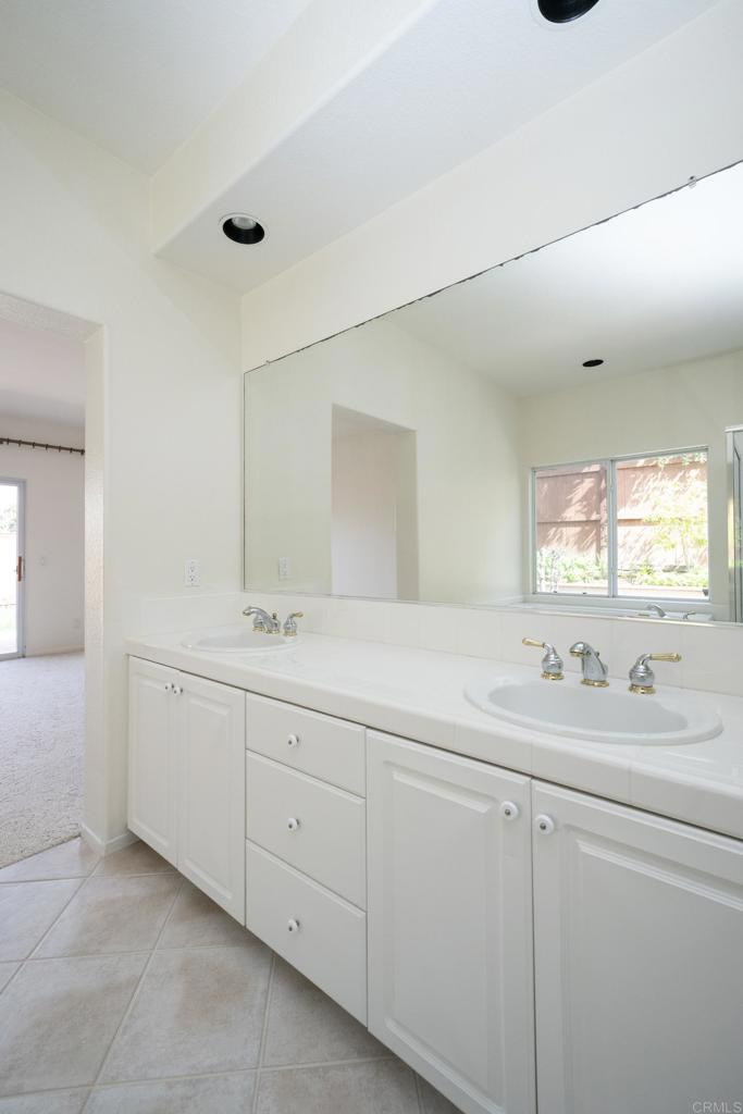 5210 Candlelight Street Oceanside, CA 92056 - Photo 19 of 30 a bathroom with a sink and mirror