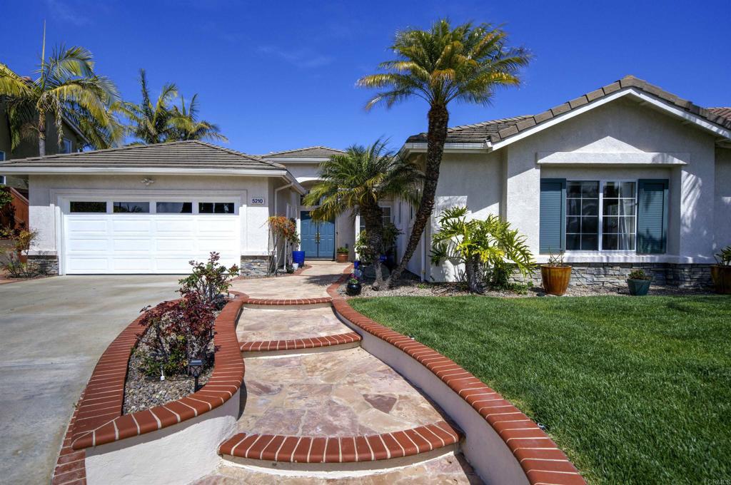 5210 Candlelight Street Oceanside, CA 92056 - Photo 2 of 30 a front view of a house with a yard