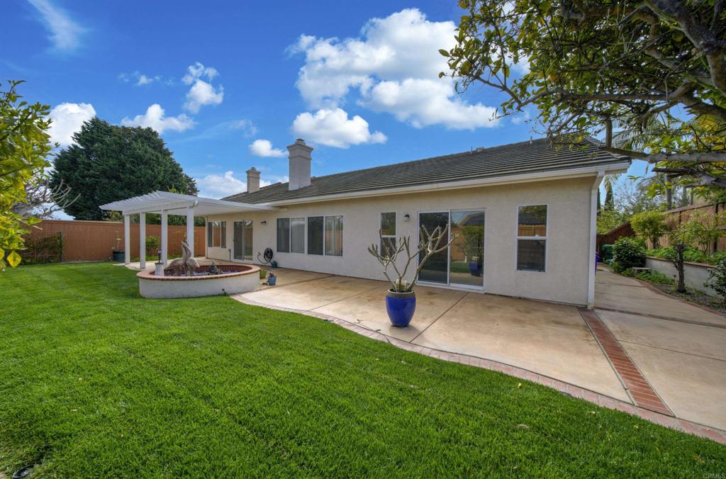 5210 Candlelight Street Oceanside, CA 92056 - Photo 23 of 30 a view of a house with a backyard porch and sitting area