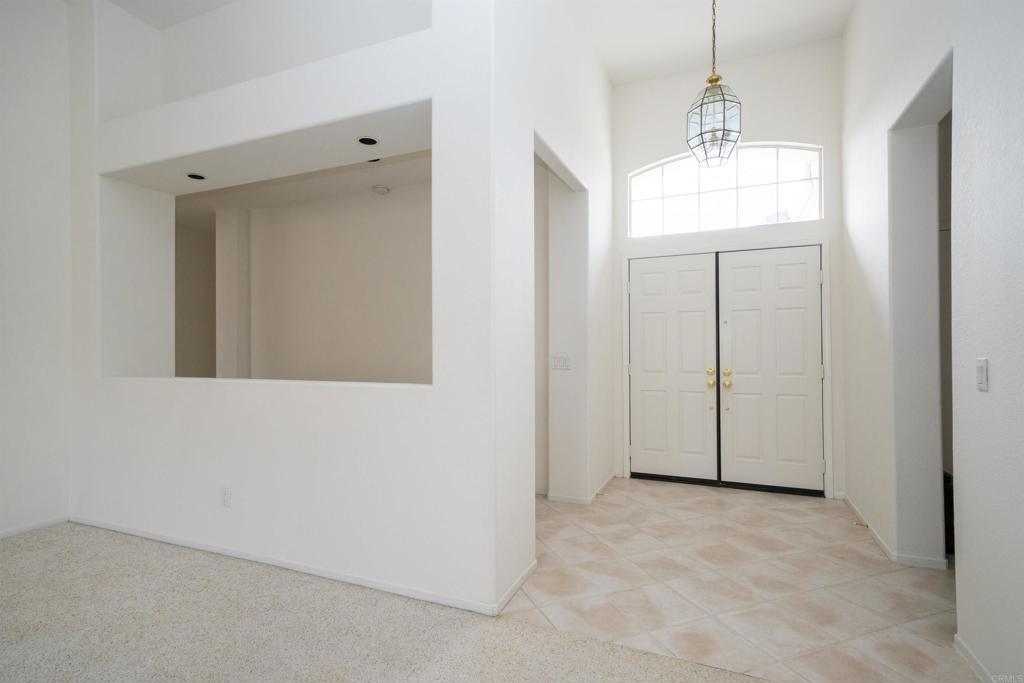 5210 Candlelight Street Oceanside, CA 92056 - Photo 9 of 30 a view of a hallway with chandelier and entryway