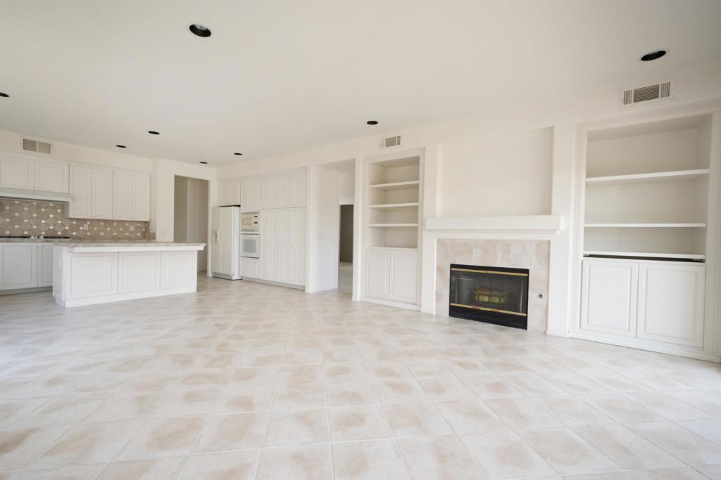 5210 Candlelight Street Oceanside, CA 92056 - Photo 10 of 30 a view of kitchen with a sink dishwasher and a fireplace