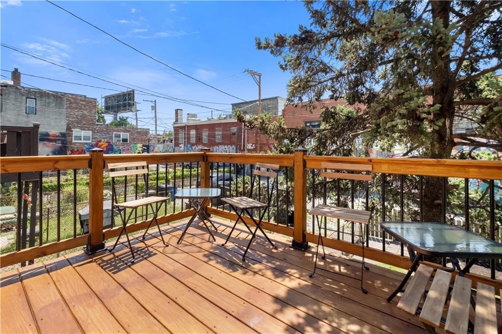 4088 Howley Street Pittsburgh, PA 15224 - Photo 15 of 32 a view of a balcony with wooden floor and outdoor seating